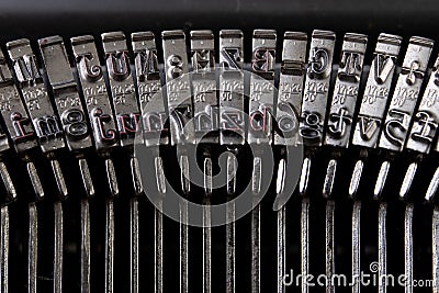 Font in a typewriter. Metal stamps for imprinting letters on a white sheet Stock Photo