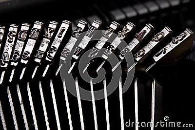 Font in a typewriter. Metal stamps for imprinting letters on a white sheet Stock Photo