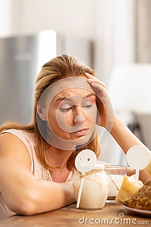 Mature appealing woman feeling tired of strong food allergies Stock Photo