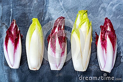 Food background, flat lay concept with fresh green Belgian endive or chicory and red Radicchio vegetables, also known as witlof Stock Photo