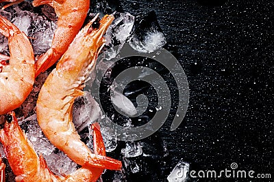 Food background, frozen cooked shrimp with ice, black background Stock Photo