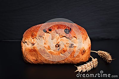 Food background Organic French whole wheat Raisin bread on black background plate Stock Photo