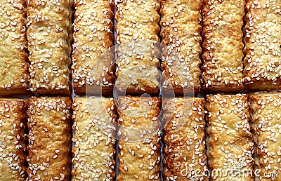 Cookies sticks sprinkled with sesame seeds are spread out on the table Stock Photo