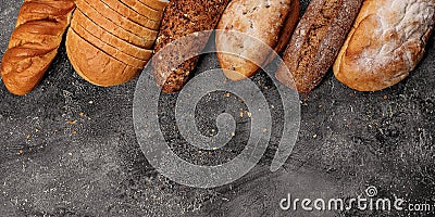 Food baking banner. Various types of fresh homemade bread on a gray concrete background. Top view. Horizontal shot. Copy space Stock Photo