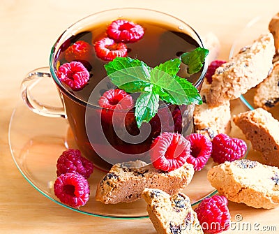 Food. black tea with raspberries, mint, cookie + Stock Photo