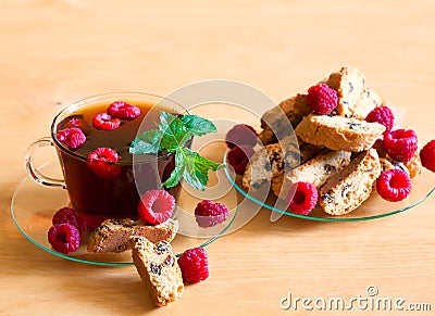 Food. black tea with raspberries, mint, cookie + Stock Photo