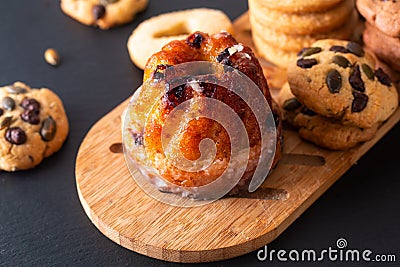 Food Breakfast or snack concept european Gugelhupf, Kougelhopf, kouglof yeast Bundt ring cake with cookies on black background Stock Photo