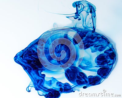 Food coloring dispersing in water Stock Photo