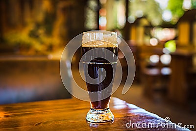 Glass with dark types of craft beer on a wooden bar. Glasses of different types of draft beer in a pub Stock Photo