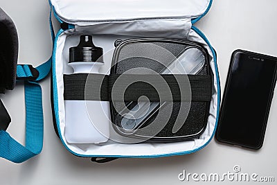 food container and bottle for drink in the thermo bag and phone on the white table. Time for dinner Stock Photo