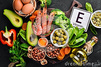 Food containing natural vitamin E: Spinach, parsley, shrimp, pumpkin seeds, eggs, avocados, broccoli. Top view. Stock Photo