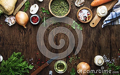 Food cooking background. Ingredients for prepare green lentils with vegetables, spices and herbs, wooden kitchen table background Stock Photo