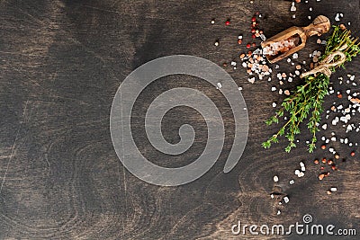Food cooking background. Spices herbs bunch thyme and seasoning salt and pepper at black slate table. Food ingredients top view Stock Photo