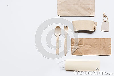 Food delivery with paper bags and flatware on gray table background top view mockup Stock Photo