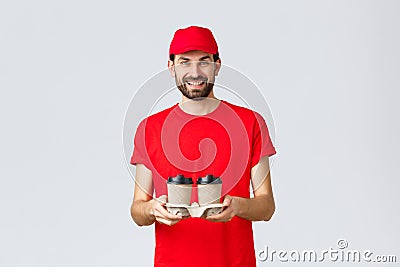 Food delivery, quarantine, stay home and order online concept. Smiling courier in red cap and t-shirt bring coffee to Stock Photo
