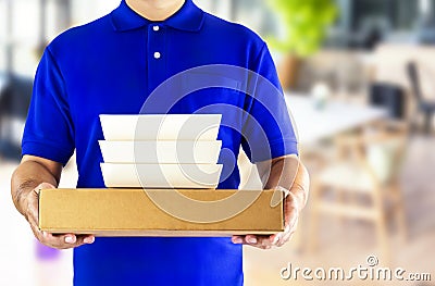 Food delivery service or order food online. Delivery man in blue Stock Photo