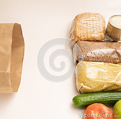 food donation. Buckwheat, eggs. cucumber, bread, apple, tomato and millet on a white background Stock Photo