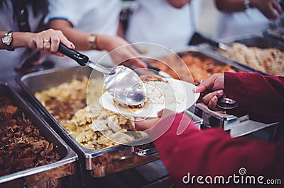 Food donation to help people in hunger relief : hands of the poor receive food from the donor`s share Stock Photo