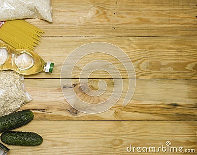Food donations on a wooden background on the side, top view with copy space. Butter, cereals, canned food. The products of the fir Stock Photo