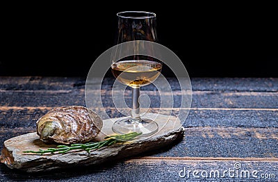 Food and drink pairing, fresh raw European flat oyster grown in Brittany in Belon river, France and scotch single malt whisky from Stock Photo