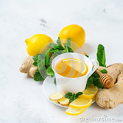 Food and drink, still life health care concept. Ginger tea infusion beverage in white cup with lemon mint honey on a kitchen table Stock Photo