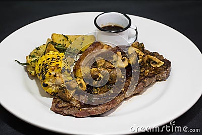 Grilled vegetables and beef steak on white plate. Stock Photo