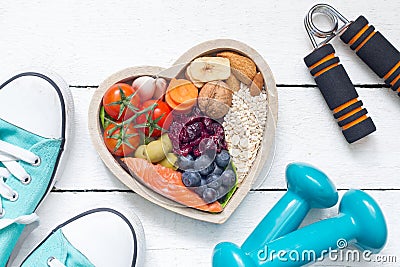 Food in heart and dumbbells fitness abstract healthy lifestyle concept Stock Photo