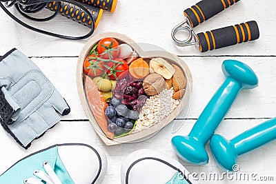Food in heart and dumbbells fitness abstract healthy lifestyle concept Stock Photo