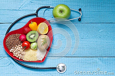 Food on heart plate with stethoscope cardiology concept Stock Photo