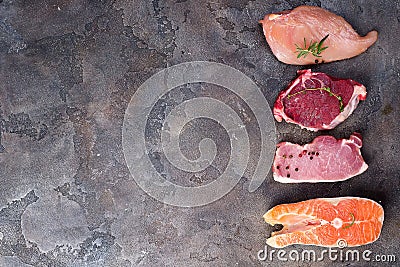 Raw chicken, meat and fish isolated on stone. Lean proteins. Stock Photo