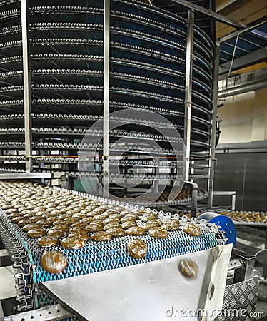 Food industry. Automatic bakery production line with sweet cookies on conveyor belt equipment machinery Stock Photo