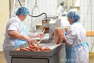 Food industry: workers in the production of original German brat Stock Photo