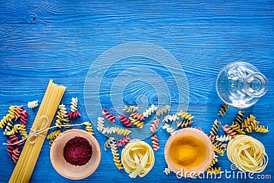 Food ingredients for Italian pasta on blue wooden desk background top view copyspace Stock Photo