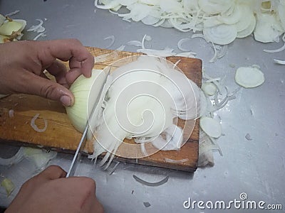 Food, knife, hand, onion, wood Stock Photo