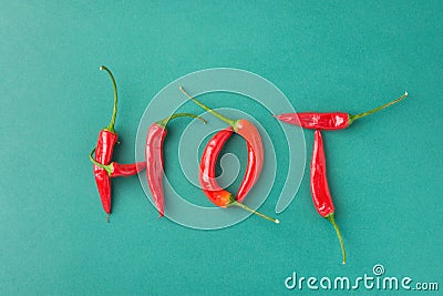 Food Lettering Typography. Word Hot Made from Red Spicy Chili Peppers on Green Background. Mexican Italian Spanish Greek Cuisine Stock Photo