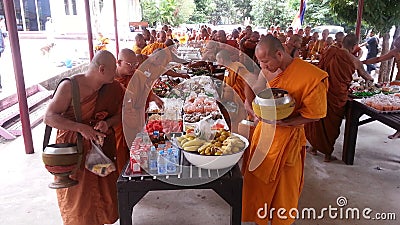 Food offerings to a monk Editorial Stock Photo