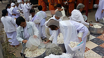 Food offerings to a monk with The villagers who come together to make merit. Editorial Stock Photo