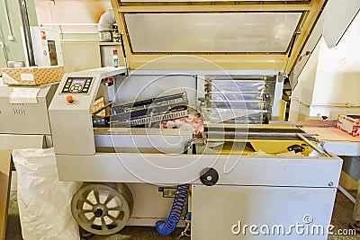 Food packing machine. Packing cookies into cardboard boxes and coating by film at confectionery production line Stock Photo