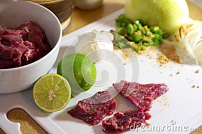 Food preparation, meat with condiments Stock Photo