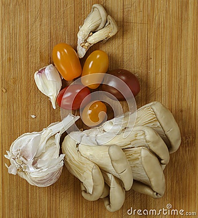 Food products - mushrooms plate with tomatoes Stock Photo