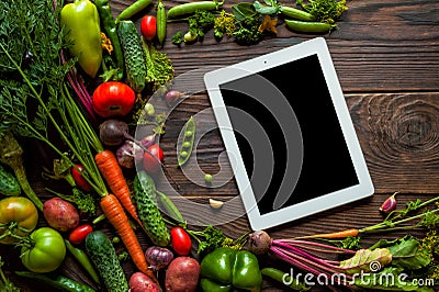 Food recipes tablet computer on rustic wooden table Stock Photo