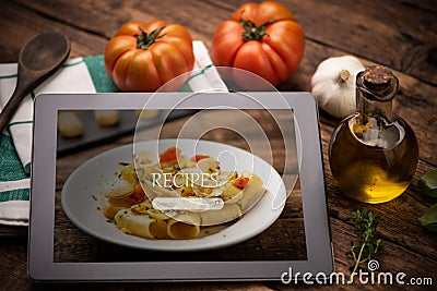 Food recipes tablet computer on rustic wooden table Stock Photo