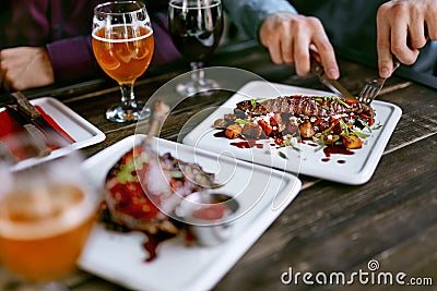 Food In Restaurant. Meat Dishes And Beer On Table Stock Photo