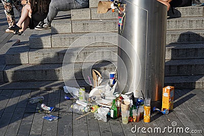 Food rubbish in and around public garbage bin in the street. Editorial Stock Photo