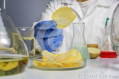 Food safety expert checking potato chips in the laboratory. Close up Stock Photo