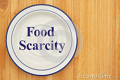 Food scarcity on empty plate on a wood table Stock Photo