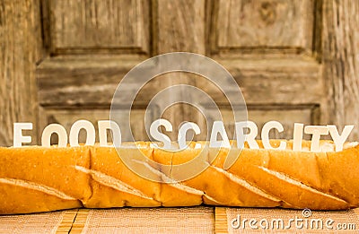 Food scarcity word on baguette Stock Photo