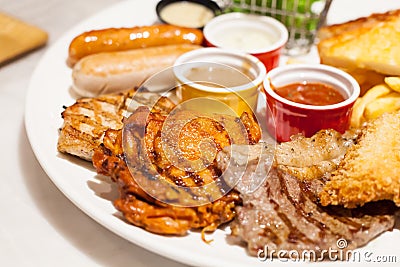 Food Steaks and Sausages Assortment Spicy Chicken, Pork, Beef, Fish served with French Fried and baked bread, sided with Stock Photo