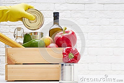 Food stocks in a wooden box. Vegetables,oil ,fruits, canned food, pasta. Donation , food delivery, coronavirus Stock Photo