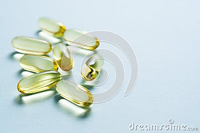 Food supplement pills, yellow softgel capsule. Omega 3 fish oil. Copy space Stock Photo